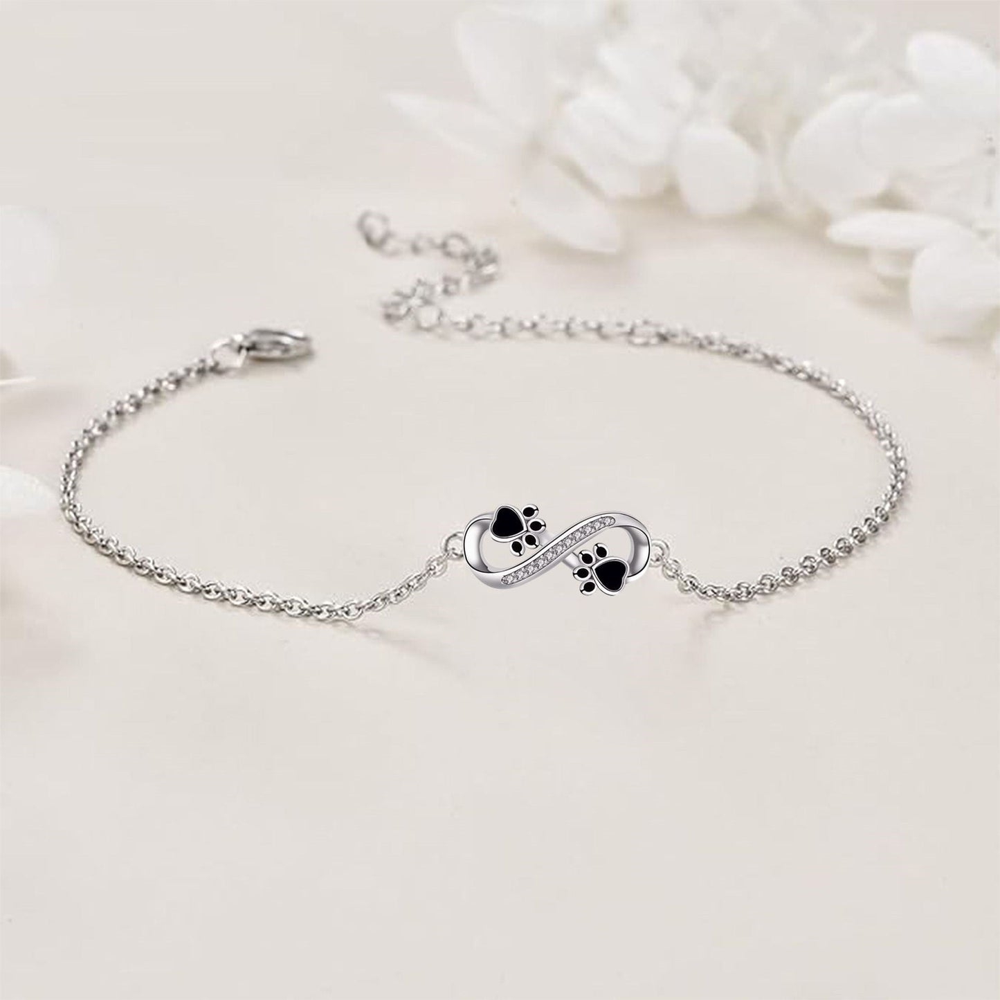 Infinity symbol bracelet with paw print charm and zirconia