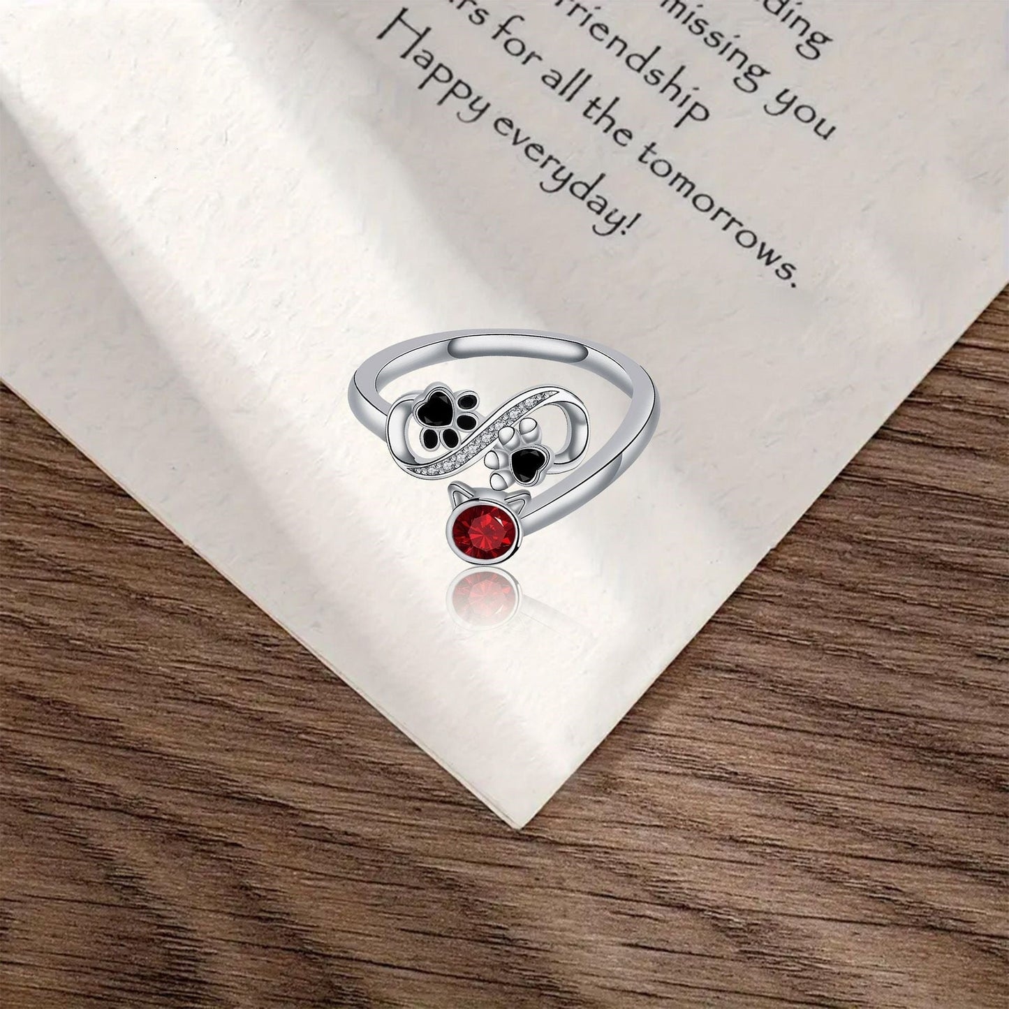 Adjustable Ring with Black Paw Prints and Red Gemstone