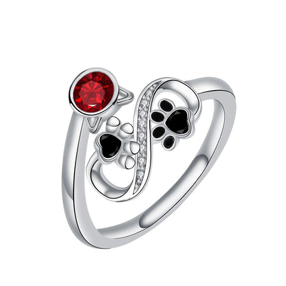 Adjustable Ring with Black Paw Prints and Red Gemstone