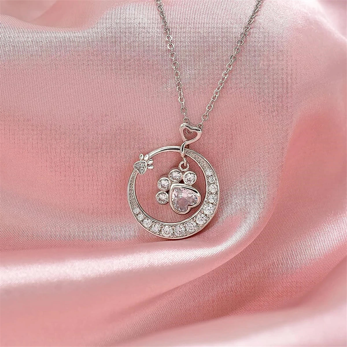 Charming silver paw print necklace with zirconia