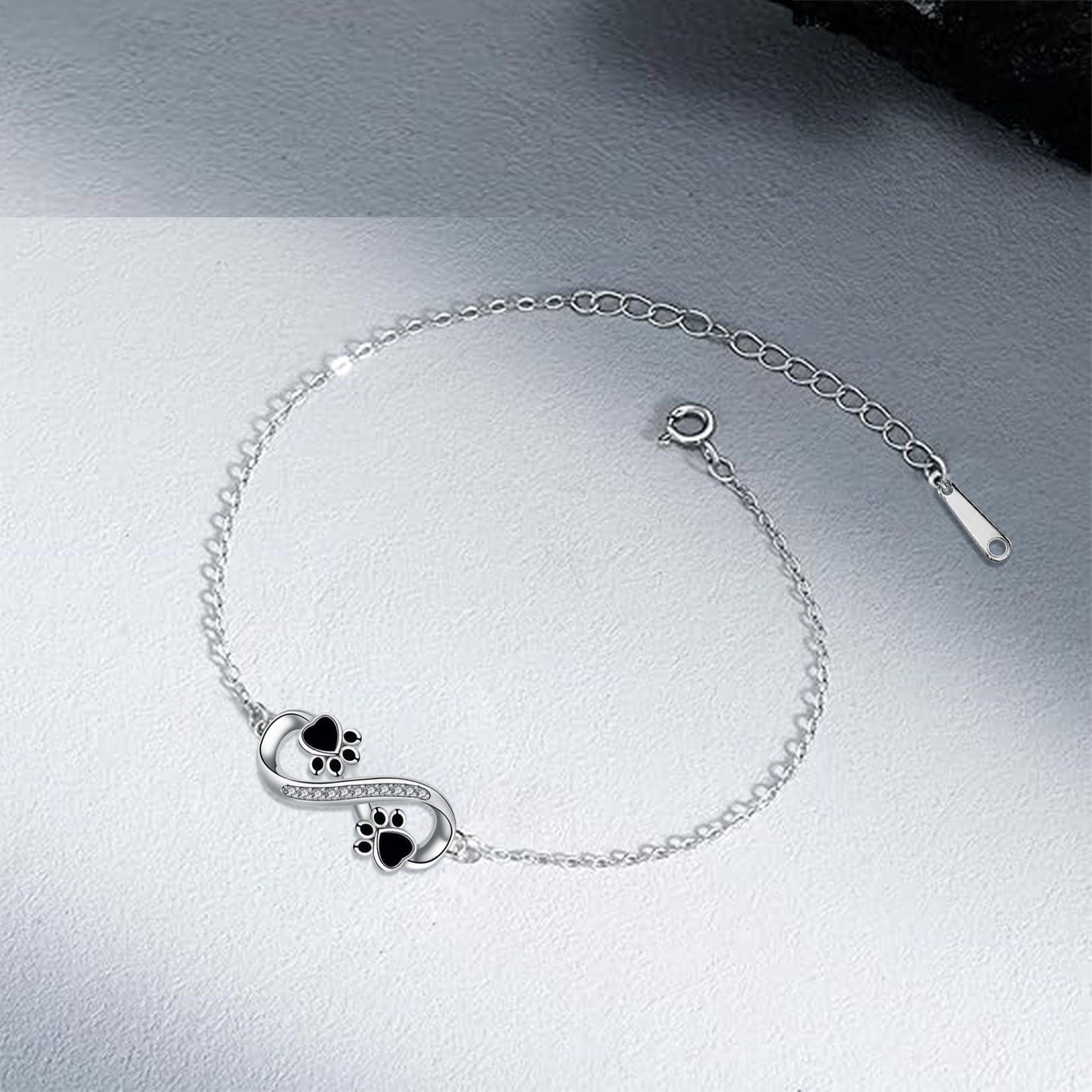 Infinity symbol bracelet with paw print charm and zirconia